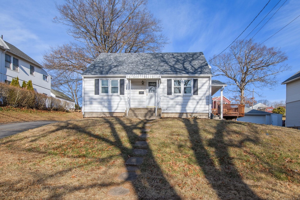 bungalow-style home with a front lawn