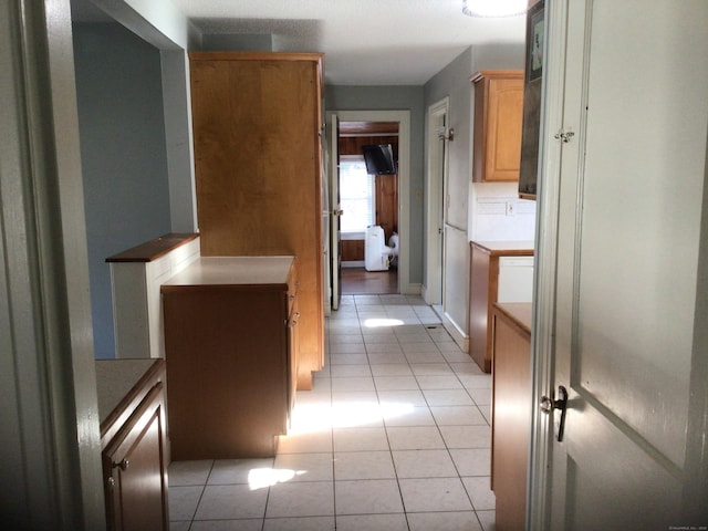 hall featuring light tile patterned flooring