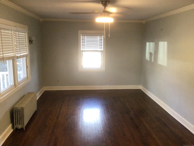 unfurnished room with crown molding, radiator heating unit, and dark wood-type flooring