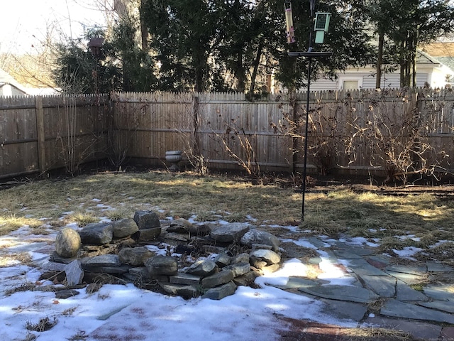 yard covered in snow featuring a garage and fence