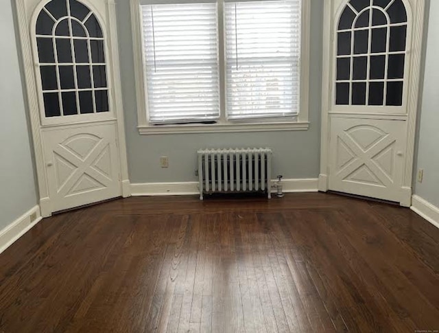 doorway to outside featuring dark wood-type flooring and radiator