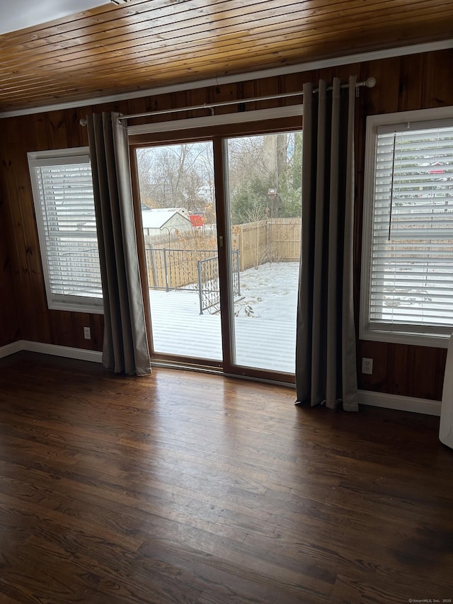 interior space with dark wood-style floors, wooden ceiling, and a healthy amount of sunlight