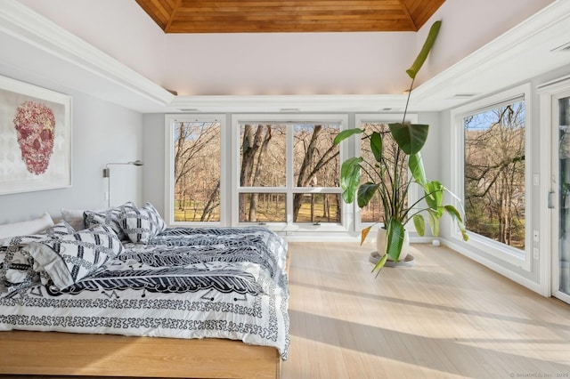 bedroom featuring multiple windows, wooden ceiling, and a raised ceiling