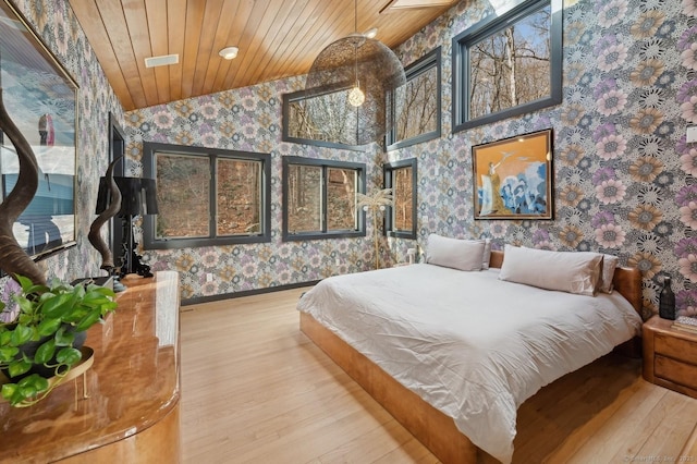 bedroom featuring lofted ceiling, wooden ceiling, and hardwood / wood-style floors