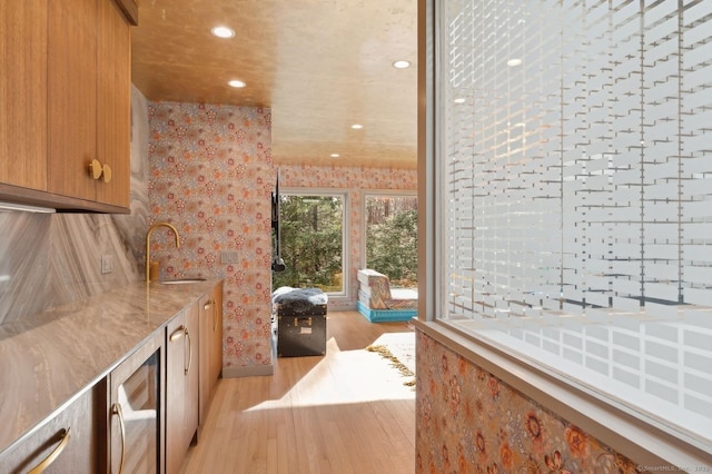 bathroom with sink, hardwood / wood-style flooring, and wine cooler