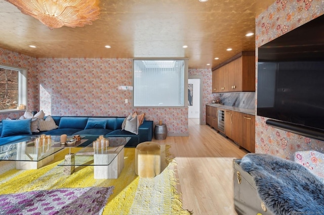 living room featuring beverage cooler and light hardwood / wood-style floors