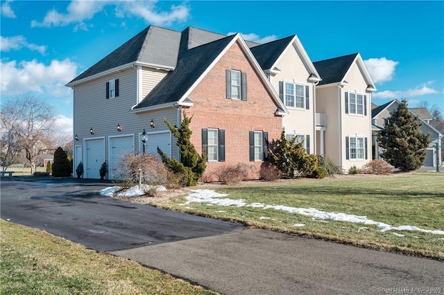 view of front of house featuring a garage and a front lawn