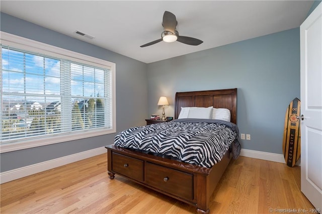 bedroom with ceiling fan and light hardwood / wood-style flooring