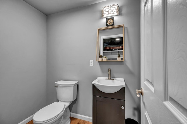 bathroom featuring hardwood / wood-style floors, toilet, and vanity