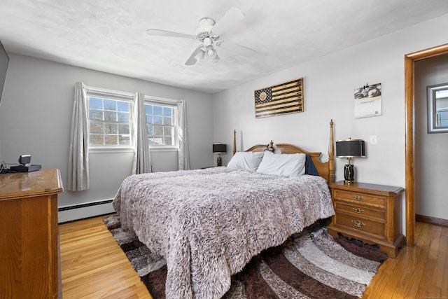 bedroom featuring a baseboard radiator, ceiling fan, and light hardwood / wood-style flooring