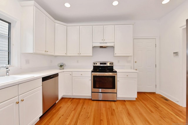 kitchen with white cabinetry, sink, light hardwood / wood-style flooring, and appliances with stainless steel finishes