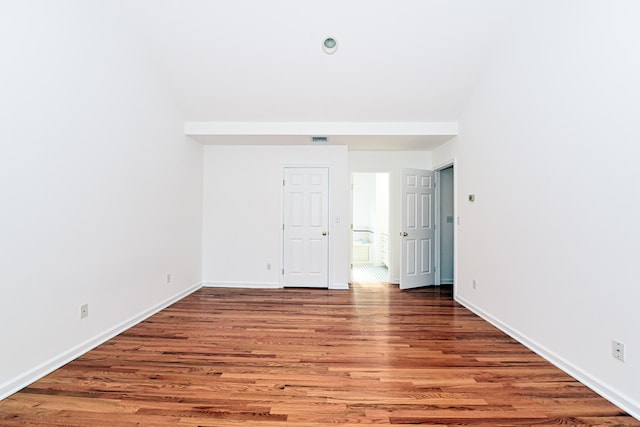 unfurnished room featuring dark hardwood / wood-style flooring