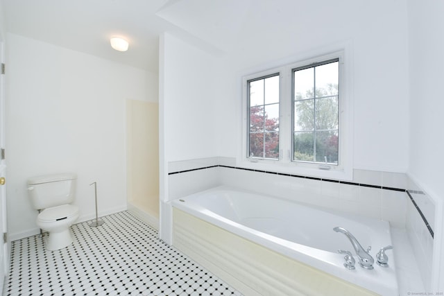 bathroom featuring tile patterned flooring, a bath, and toilet