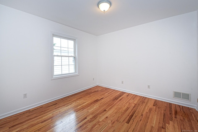 unfurnished room featuring wood-type flooring