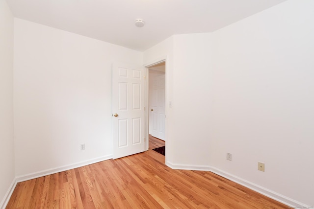 unfurnished room with light wood-type flooring