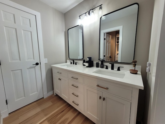 bathroom with hardwood / wood-style floors and vanity