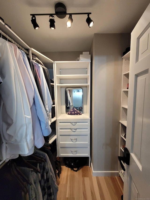 walk in closet featuring light hardwood / wood-style floors