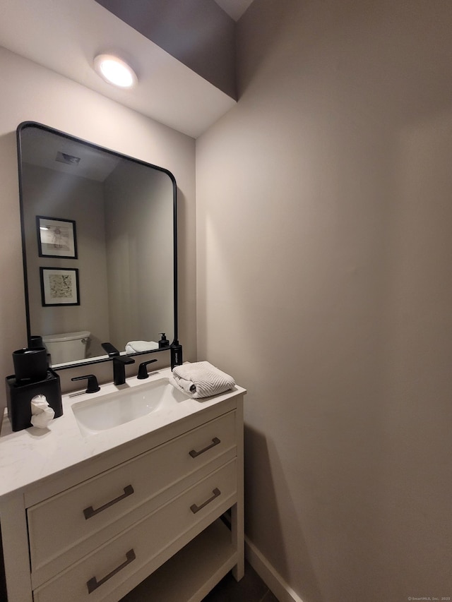 bathroom with vanity and toilet