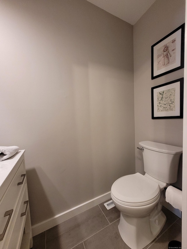 bathroom with toilet, tile patterned floors, and vanity