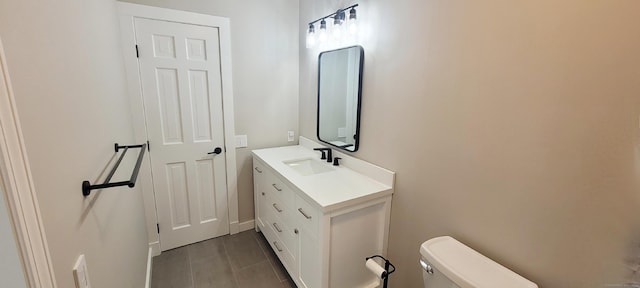 bathroom featuring toilet, vanity, and tile patterned floors