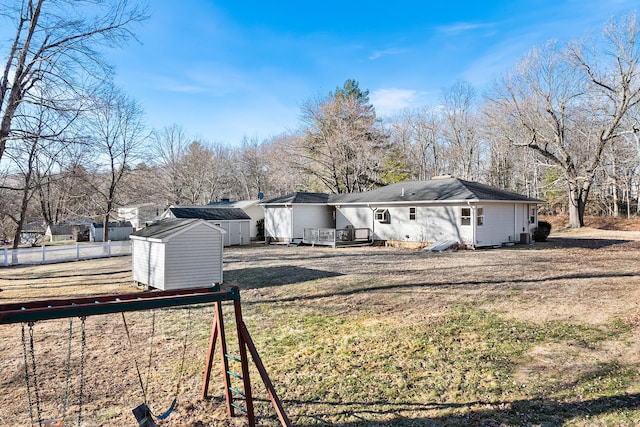 exterior space featuring a yard, a storage shed, and a wooden deck