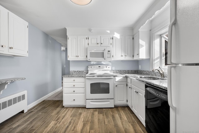 kitchen with white appliances, white cabinetry, sink, and radiator