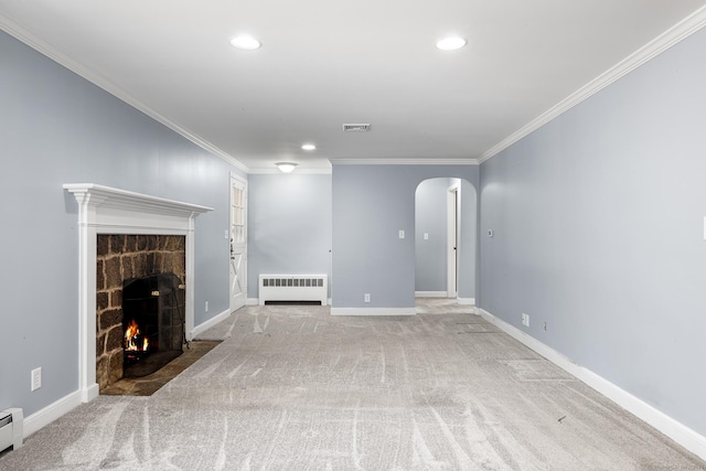 unfurnished living room with baseboard heating, crown molding, radiator heating unit, and a stone fireplace