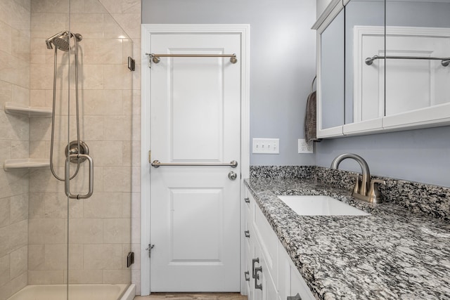 bathroom featuring an enclosed shower and vanity