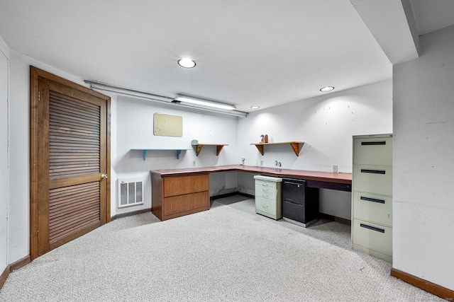 carpeted home office with built in desk