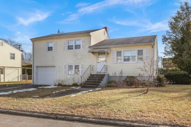 tri-level home with a front lawn and a garage