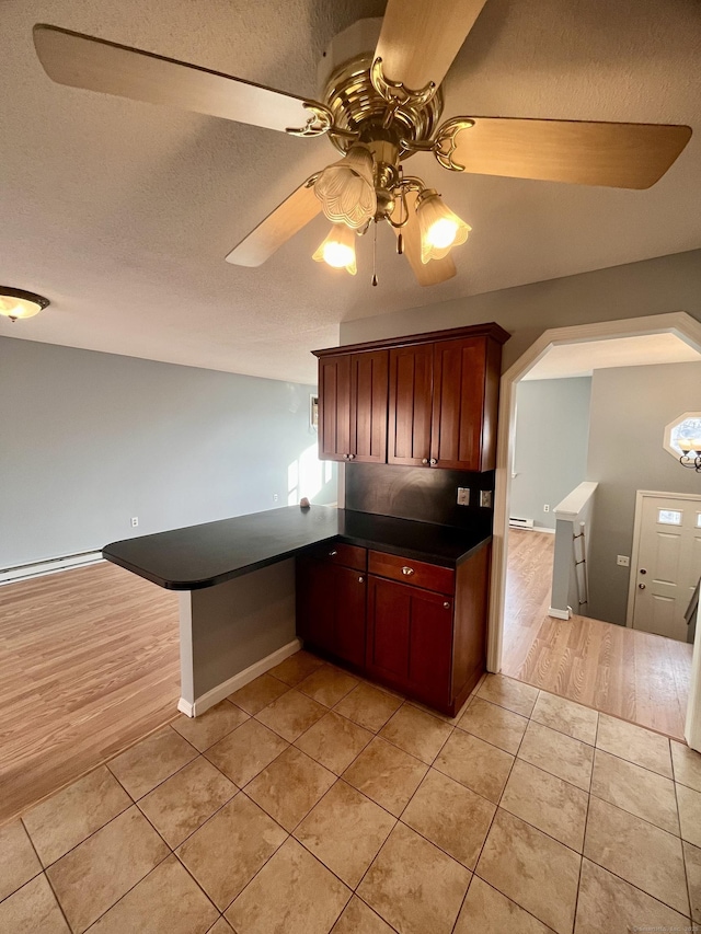 kitchen with ceiling fan, light tile patterned floors, and kitchen peninsula