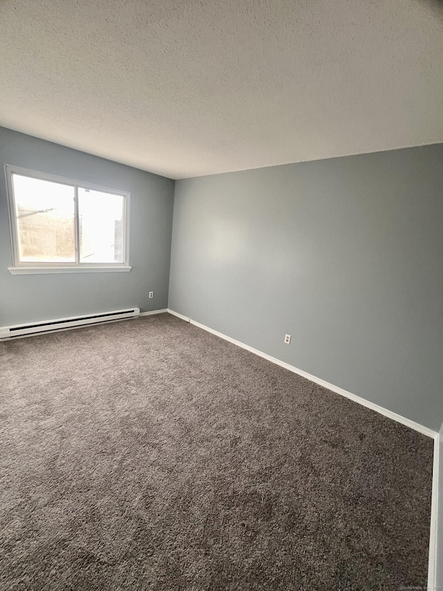 carpeted spare room featuring baseboard heating and a textured ceiling