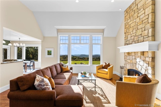 living room with a fireplace, plenty of natural light, a mountain view, and a notable chandelier