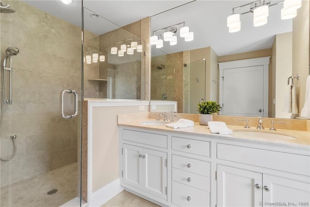 bathroom with walk in shower and vanity