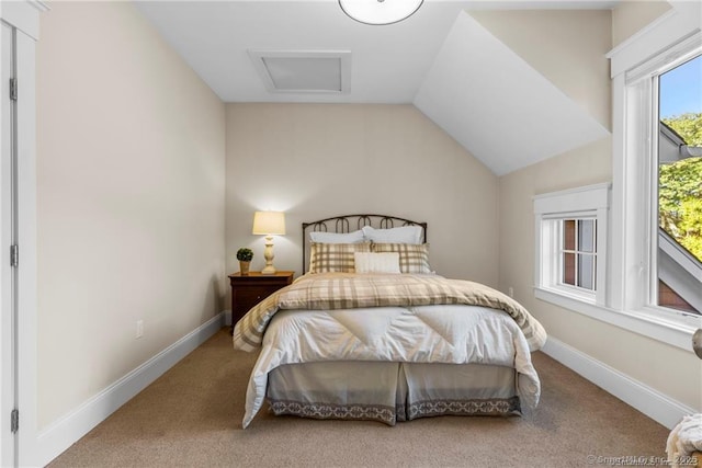 bedroom featuring lofted ceiling and carpet