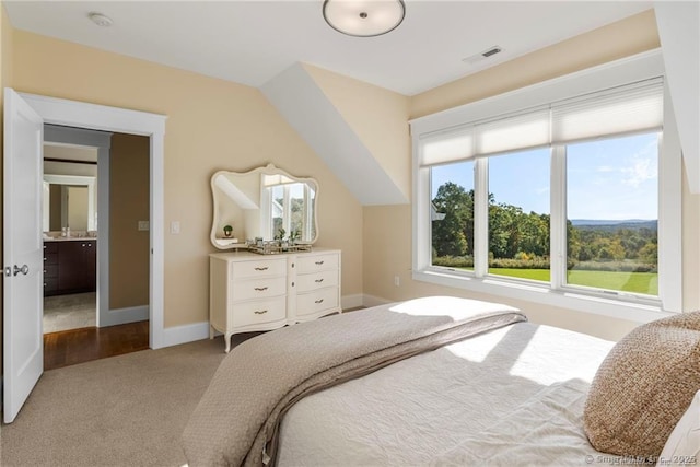 carpeted bedroom with vaulted ceiling