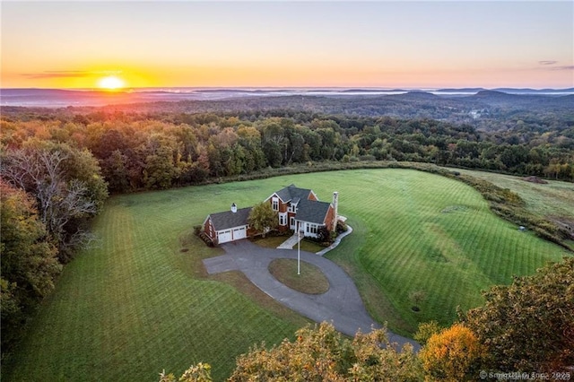 aerial view at dusk featuring a rural view