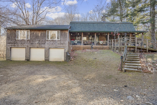 view of front of house with a porch and a garage