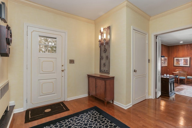 entrance foyer featuring ornamental molding, radiator heating unit, and dark hardwood / wood-style floors