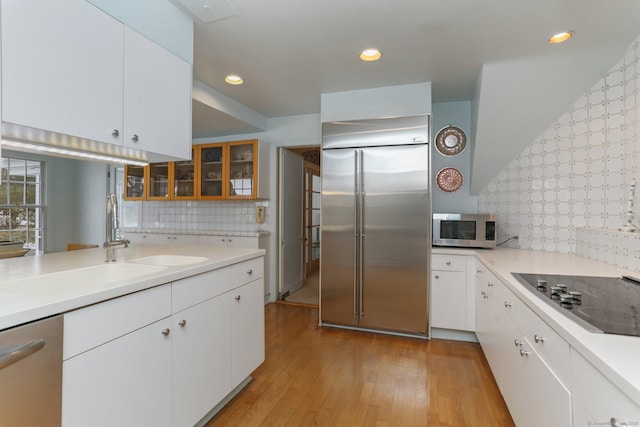 kitchen with white cabinetry, light hardwood / wood-style flooring, and appliances with stainless steel finishes