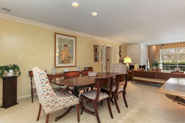 carpeted dining area featuring ornamental molding