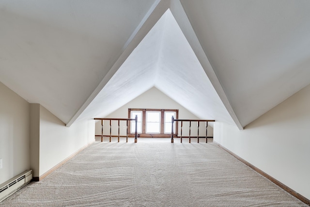 additional living space featuring lofted ceiling, a baseboard heating unit, and carpet floors