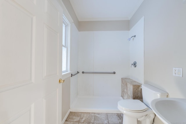 bathroom with ornamental molding, a shower, sink, and toilet