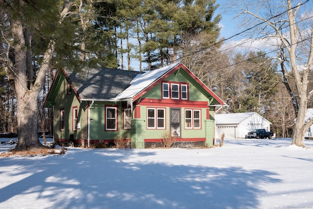 view of front facade featuring a garage and an outdoor structure