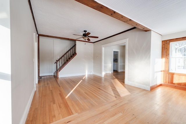 unfurnished room featuring crown molding, beamed ceiling, ceiling fan, and light wood-type flooring