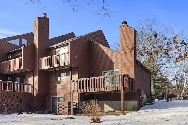 snow covered property featuring a balcony