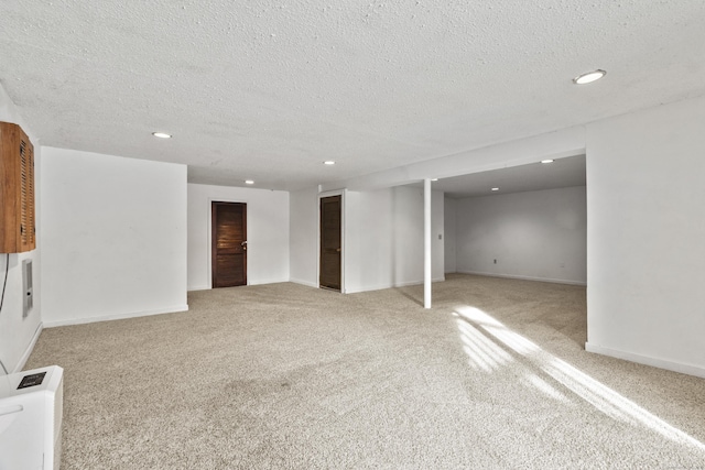 basement with light carpet and a textured ceiling