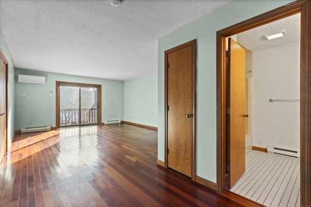 unfurnished living room featuring a baseboard radiator, dark wood-type flooring, and a wall mounted air conditioner