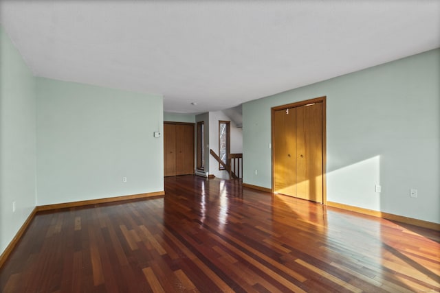 unfurnished room with dark hardwood / wood-style floors