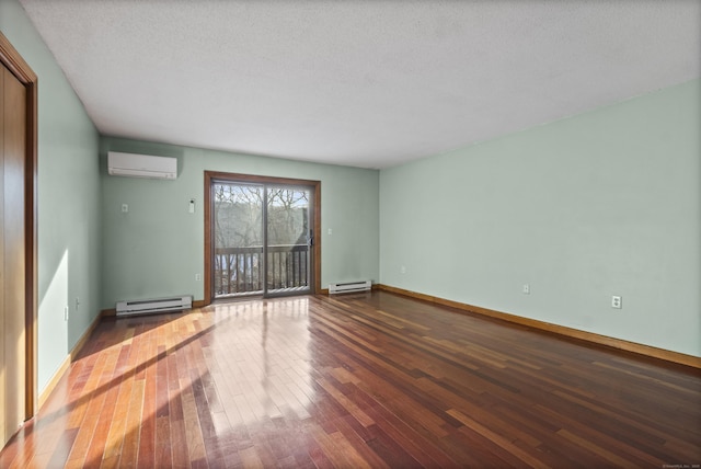 empty room with a baseboard radiator, dark hardwood / wood-style flooring, a wall unit AC, and a textured ceiling